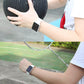 Black rubber sport watch band with pin-and-tuck closure on an Apple Watch
