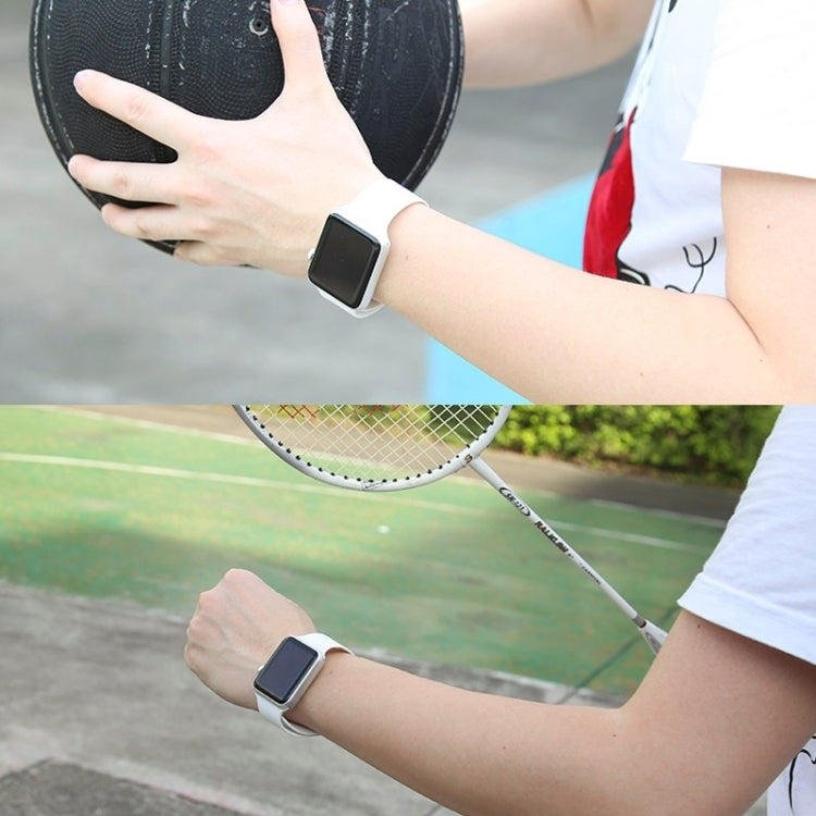 Black rubber sport watch band with pin-and-tuck closure on an Apple Watch