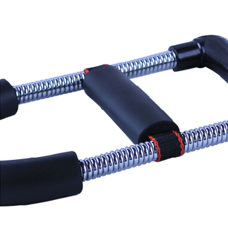 Wrist strength exerciser close-up with chrome springs, black foam grips, and red band wrap