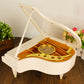 White music box piano with open lid showing golden wheel and internal parts