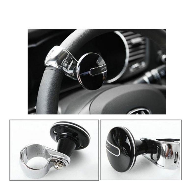 Steering wheel spinner knob attached to a dark steering wheel with chrome mount