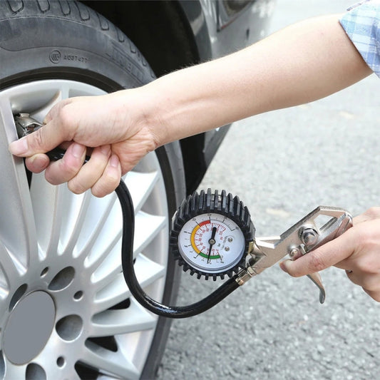 Car tire inflator gauge kit with black hose and round pressure dial attached to clamp