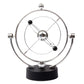 Kinetic orbital desk toy with chrome orbit ring and black pedestal base