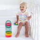 Rainbow spring coil ring toy with child playing on stairs, multicolor stacked coil