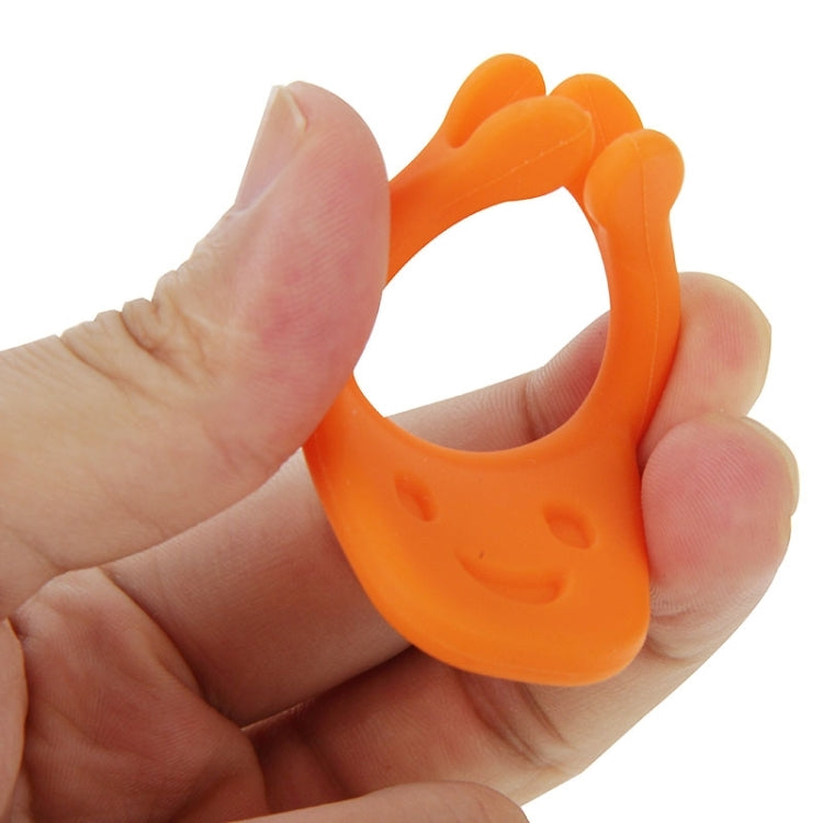 Orange U-shaped smile maker dental tool held between fingers