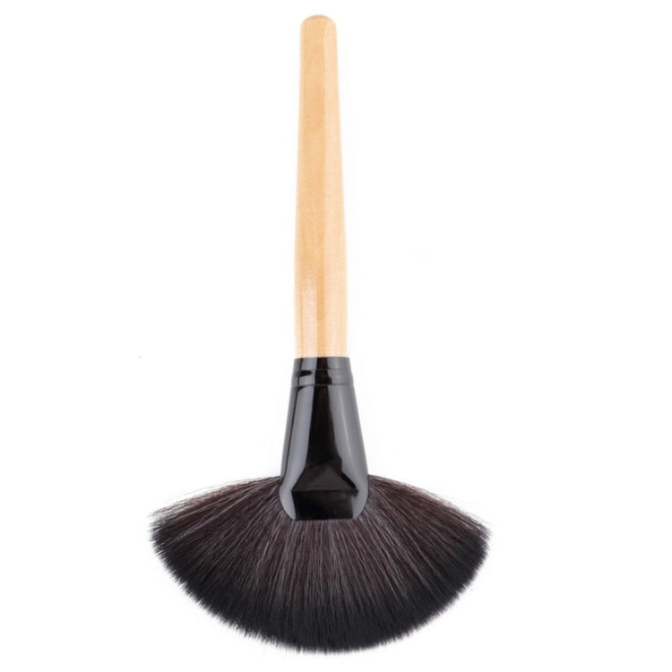 Fan makeup brush with dark bristles and light wooden handle