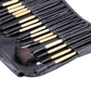 Black leather brush pouch interior with wooden-handled brushes and bristle tips