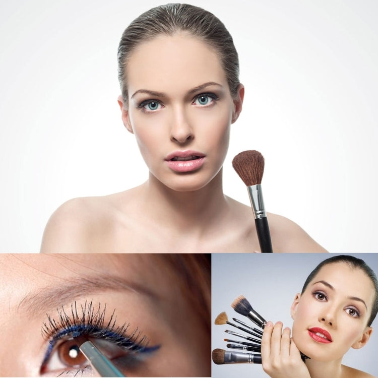 Makeup brush applying brown bristles to cheek on face