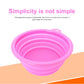 Pink collapsible silicone pet feeder bowl with side handle, empty