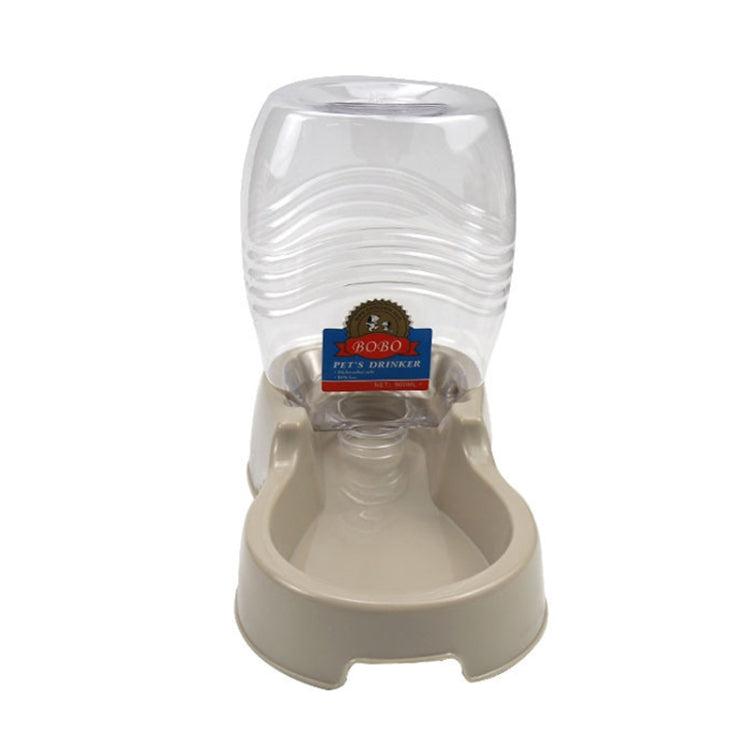 Automatic pet drinking fountain dispenser with clear bottle and beige dish feeder base