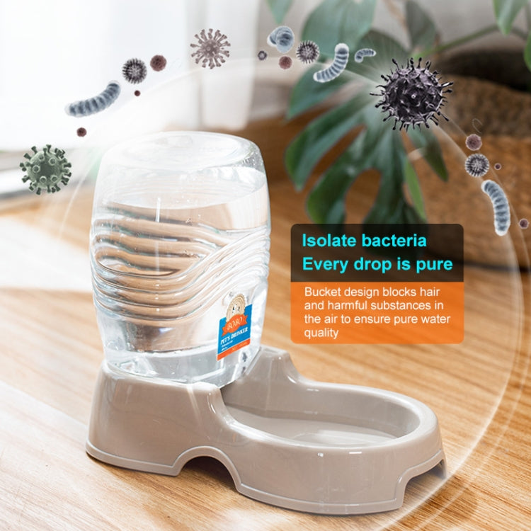 Clear water bottle on beige automatic pet dispenser base with side bowl