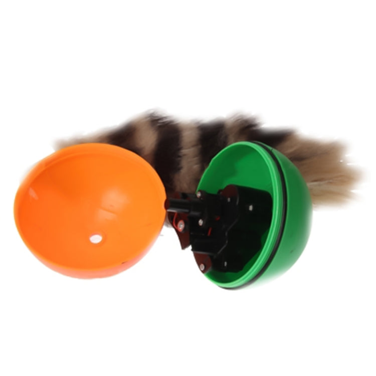 Motorized rolling chaser ball toy with orange outer shell and green side casing