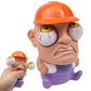 Orange hard-hat cartoon character toy with purple body, small doll held in left hand.
