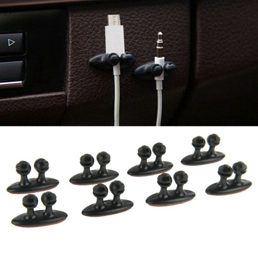 Black car cable bundle clips with adhesive, two clips holding cables on dashboard