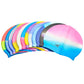 Assorted rainbow silicone swimming caps stacked together, each with front logo
