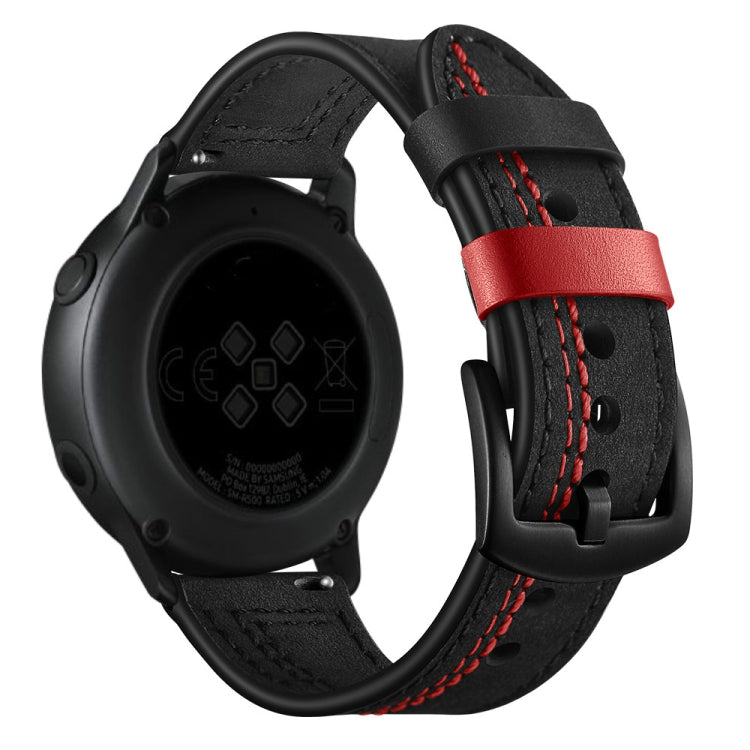 Black leather watch strap with red stitch and buckle, paired with a dark watch case
