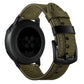 Olive green leather watch strap with blue stitching and metal buckle, with dark watch case