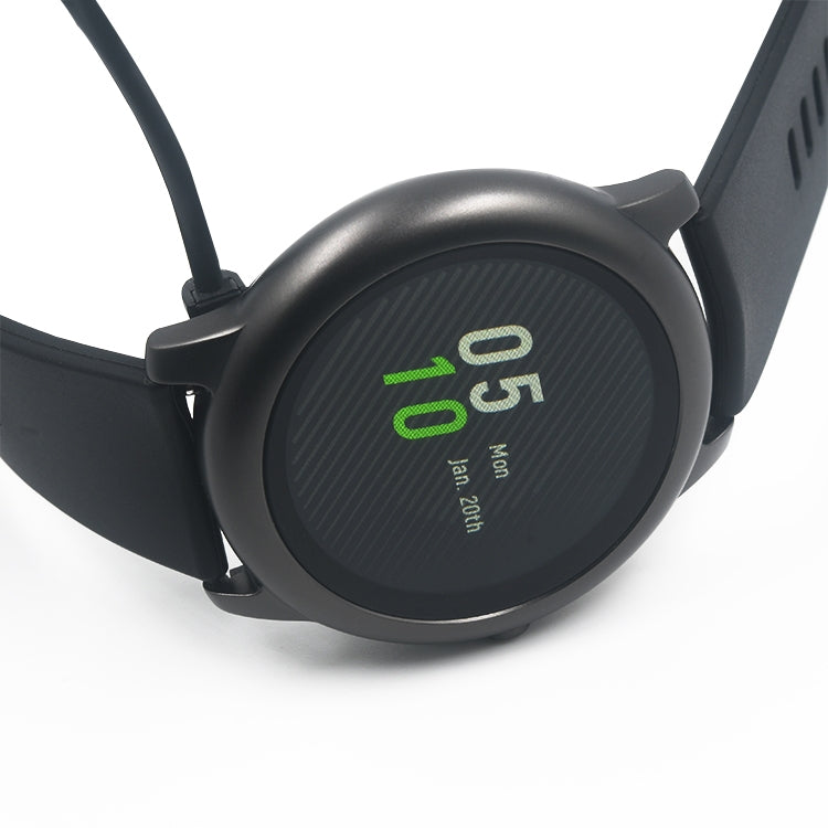 Magnetic watch charger puck with attached cable, dark gray with green indicator text