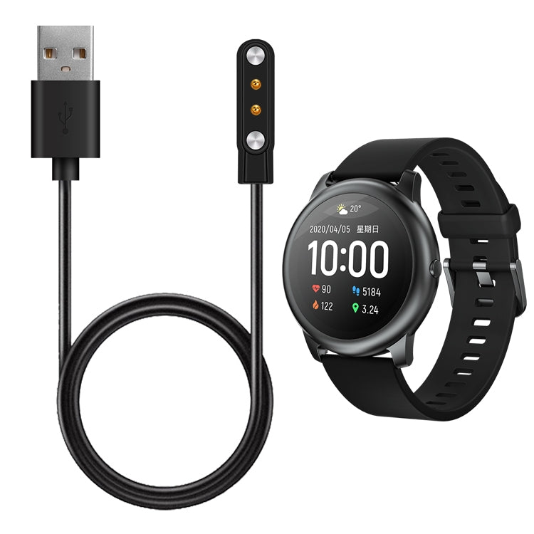 Magnetic charging cable connected to a black smartwatch