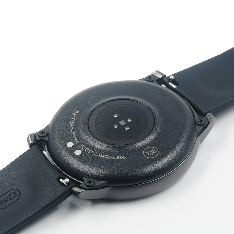 Close-up: magnetic charger puck on the back of a black smartwatch