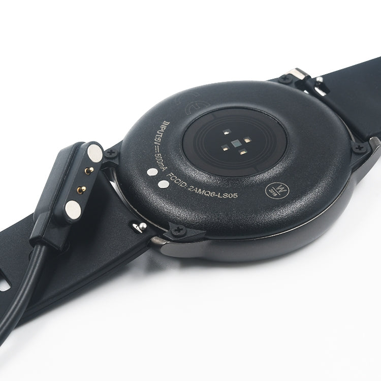 Close-up: magnetic charging puck and connector on a black smartwatch