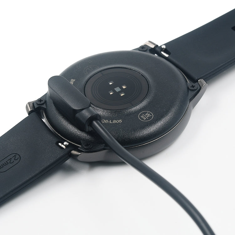 Close-up: magnetic charger puck and cable at the back of a smartwatch