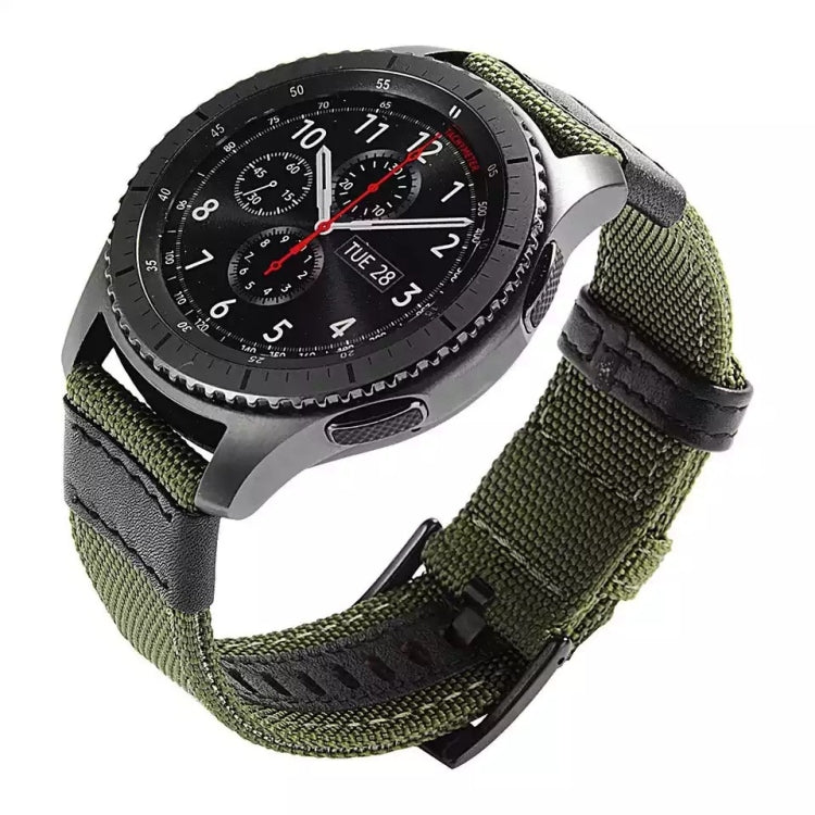 Olive green canvas watch strap with black side trim and metal buckle