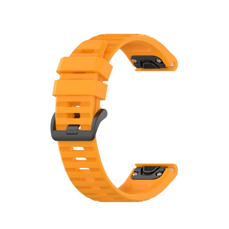 Orange silicone sports watch strap with perforated ventilated band and adjustable buckle.