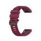 Wine red silicone sports watch strap with perforated band and adjustable buckle.