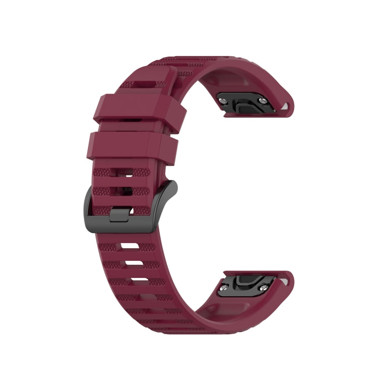 Wine red silicone sports watch strap with perforated band and adjustable buckle.