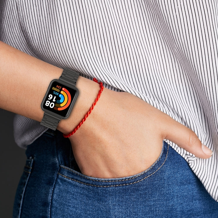 Black three-bead metal watch strap with protective frame worn on wrist