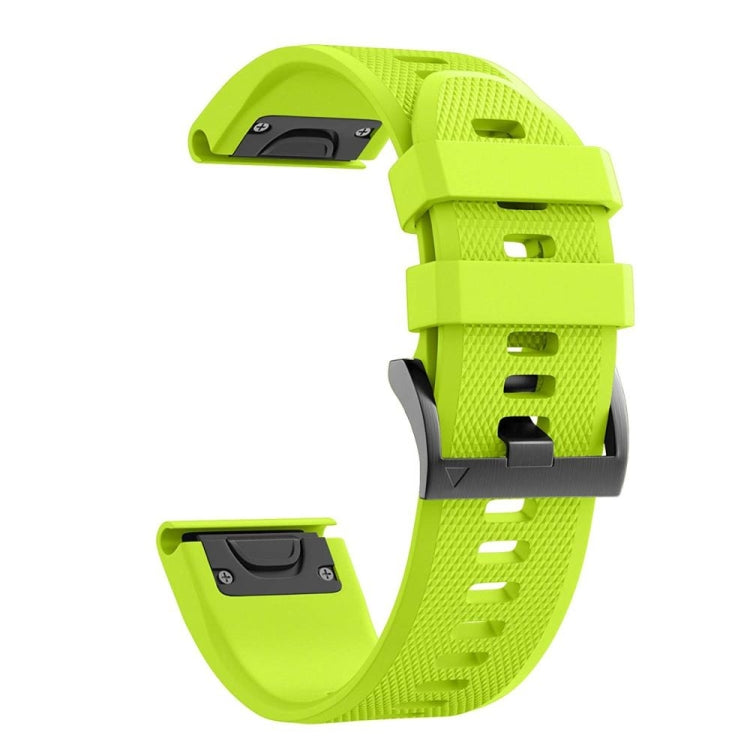 Bright green silicone watch strap with perforated texture and buckle clasp.