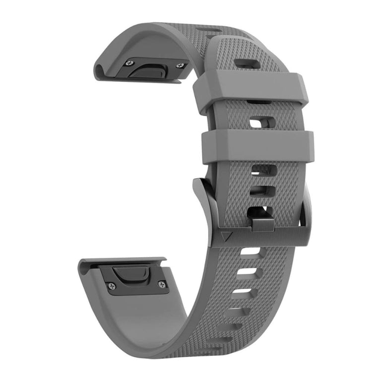 Grey silicone watch strap with holes and folding clasp on black hardware.