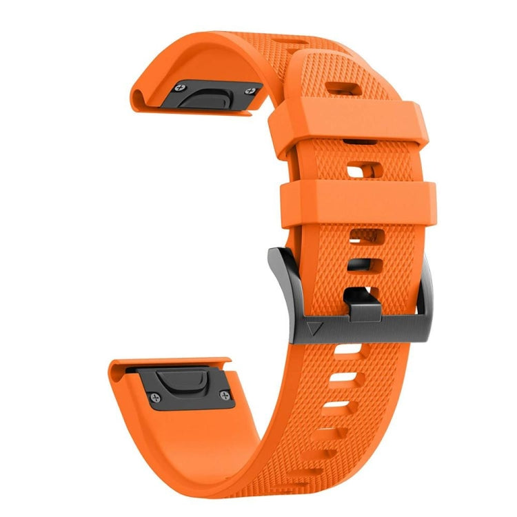 Orange silicone watch strap with textured grip surface and adjustment holes