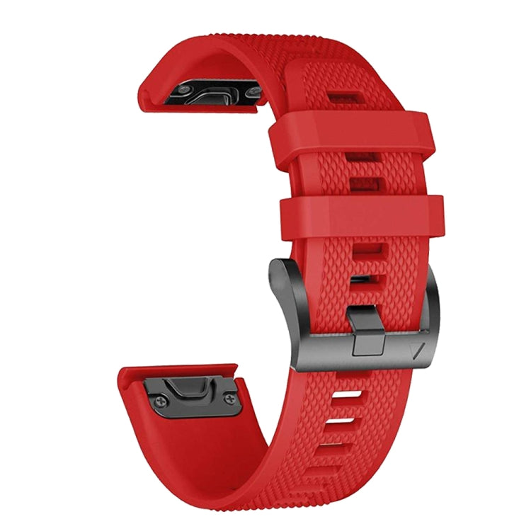 Red silicone watch band with textured surface, buckle hardware, and underside strap