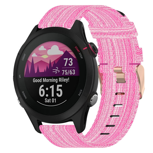 Pink woven nylon watch band with metal clasp and adjustment holes.