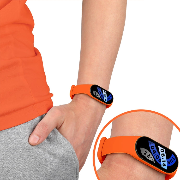 Orange TPU adjustable watch band on wrist with fitness tracker display