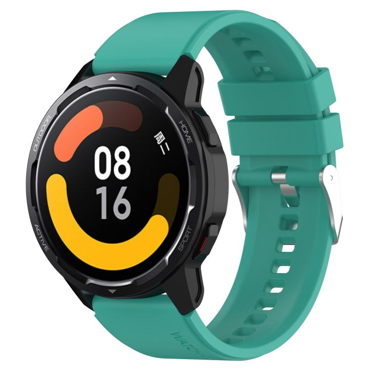 Silicone smartwatch strap with silver buckle, teal-green band with perforated holes