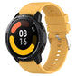 Yellow silicone smartwatch strap with protruding head silver buckle; round watch face visible