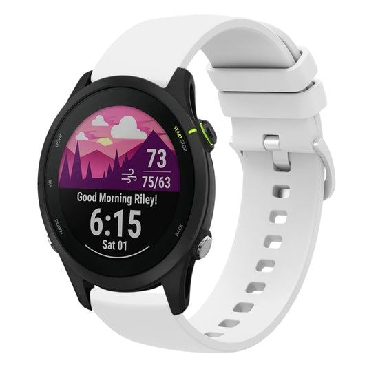 White soft silicone watch band with perforated strap and clasp on a round smartwatch.