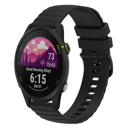 Black silicone wavy dotted watch band with buckle and row of ventilation holes.