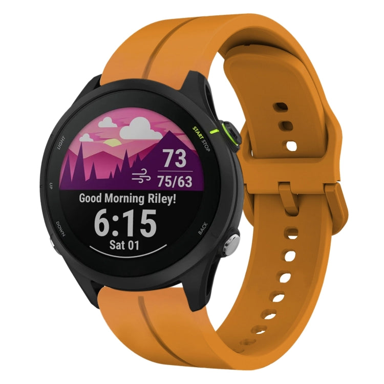 Amber yellow silicone watch band with perforations and clasp, attached to a smartwatch
