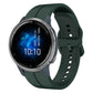 Dark green silicone watch strap with perforations and clasp, smartwatch on wrist