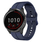 Navy blue silicone watch band with multiple holes and round dark smartwatch case