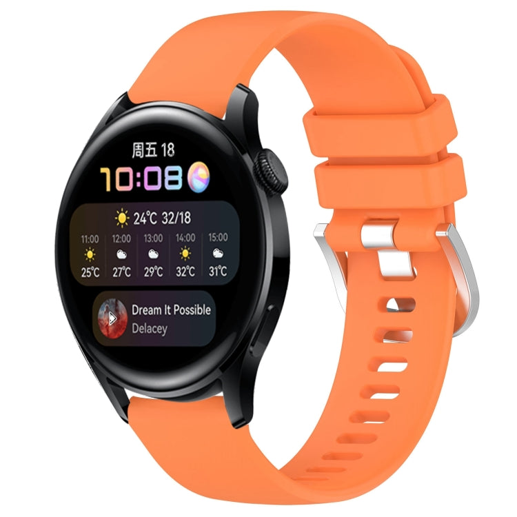 Orange silicone watch band with silver-tone buckle and adjustable vented strap holes