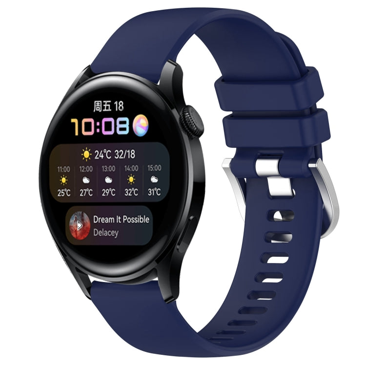 Navy blue silicone watch band with glossy buckle and perforated strap, smartwatch attached