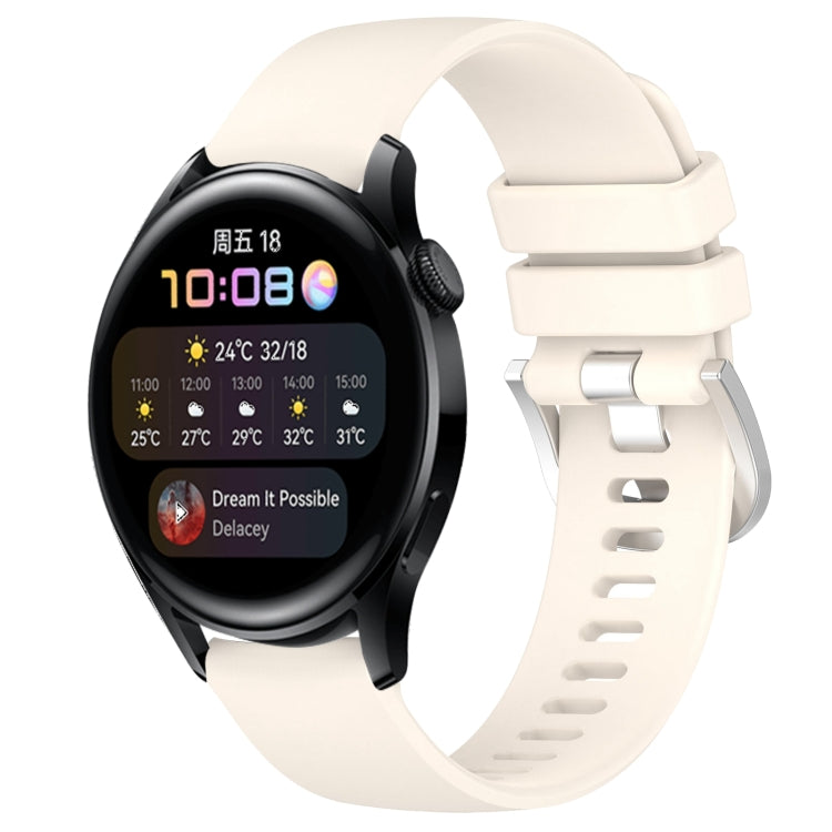 White silicone watch band with glossy buckle and perforated strap, smartwatch attached