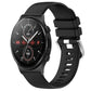 Black silicone watch band with glossy buckle and perforated strap, smartwatch attached