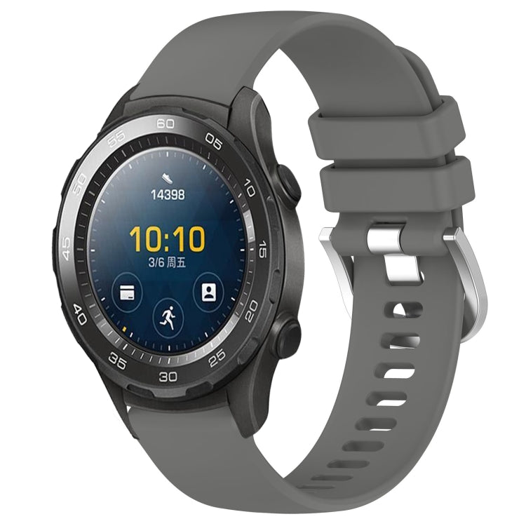 Gray glossy silicone watch band with silver buckle, adjustable holes and secure clasp.
