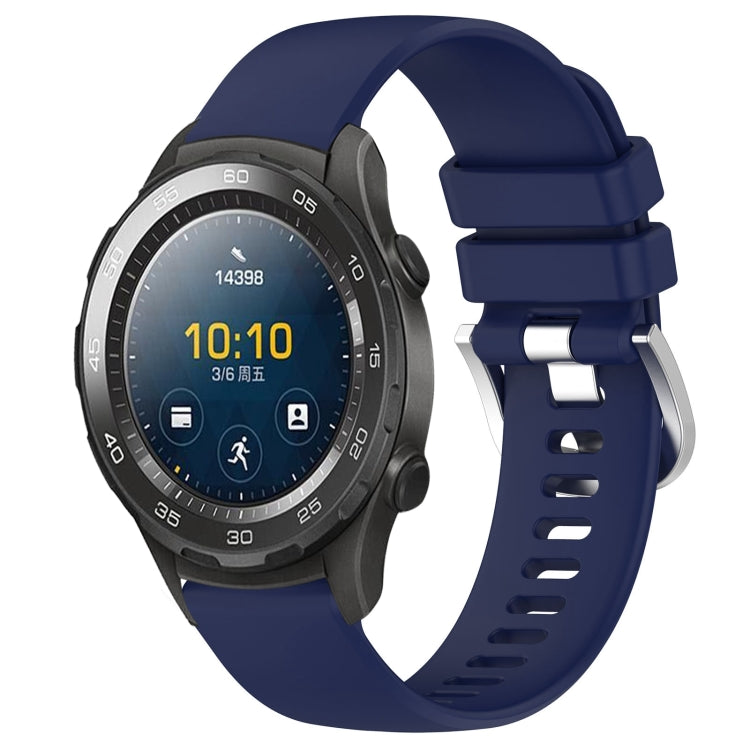 Blue glossy silicone watch band with silver buckle, adjustable holes and secure clasp.